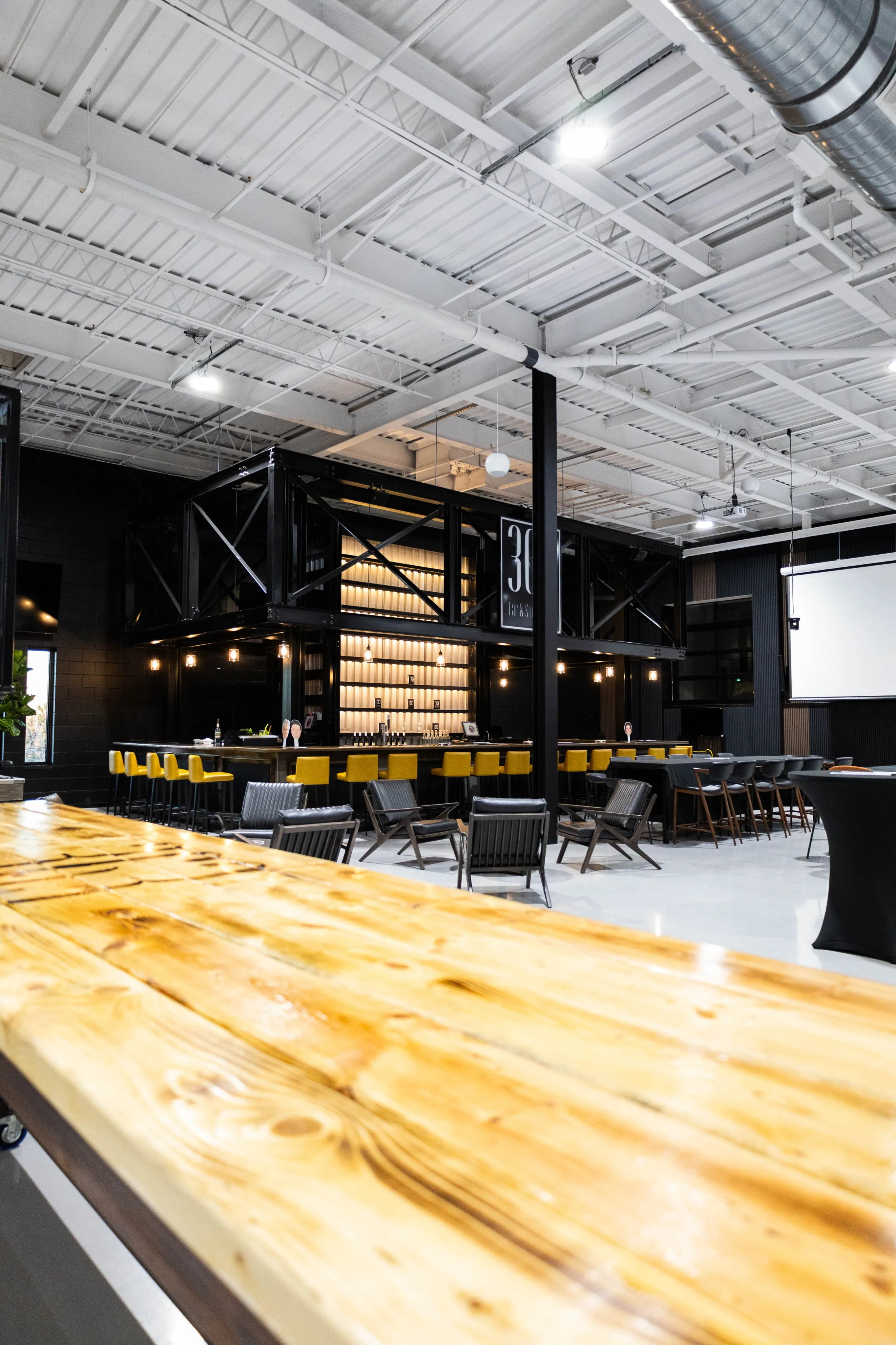 A fancy, well-lit bar in a large room