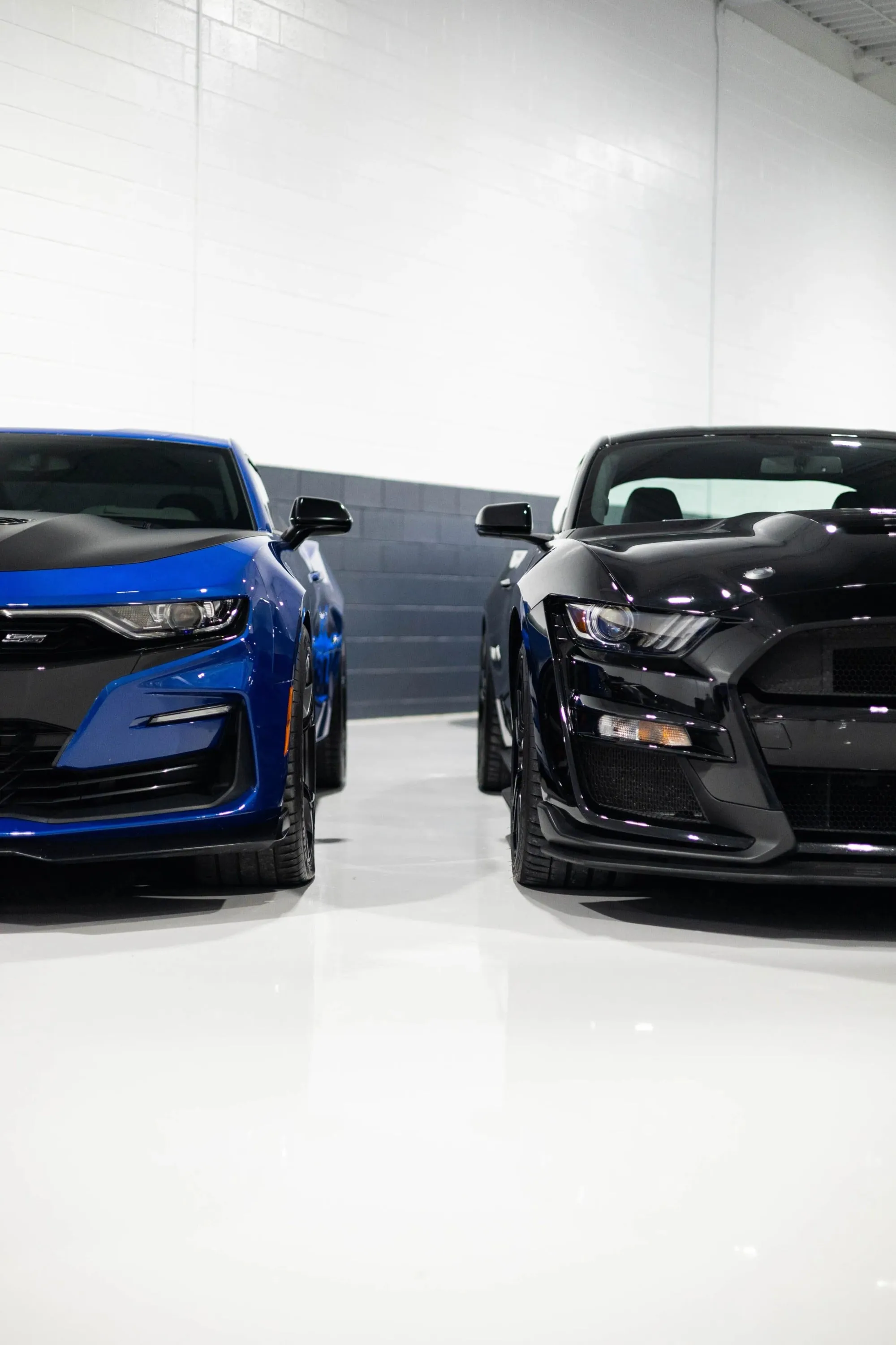 Two cars parked in a garage