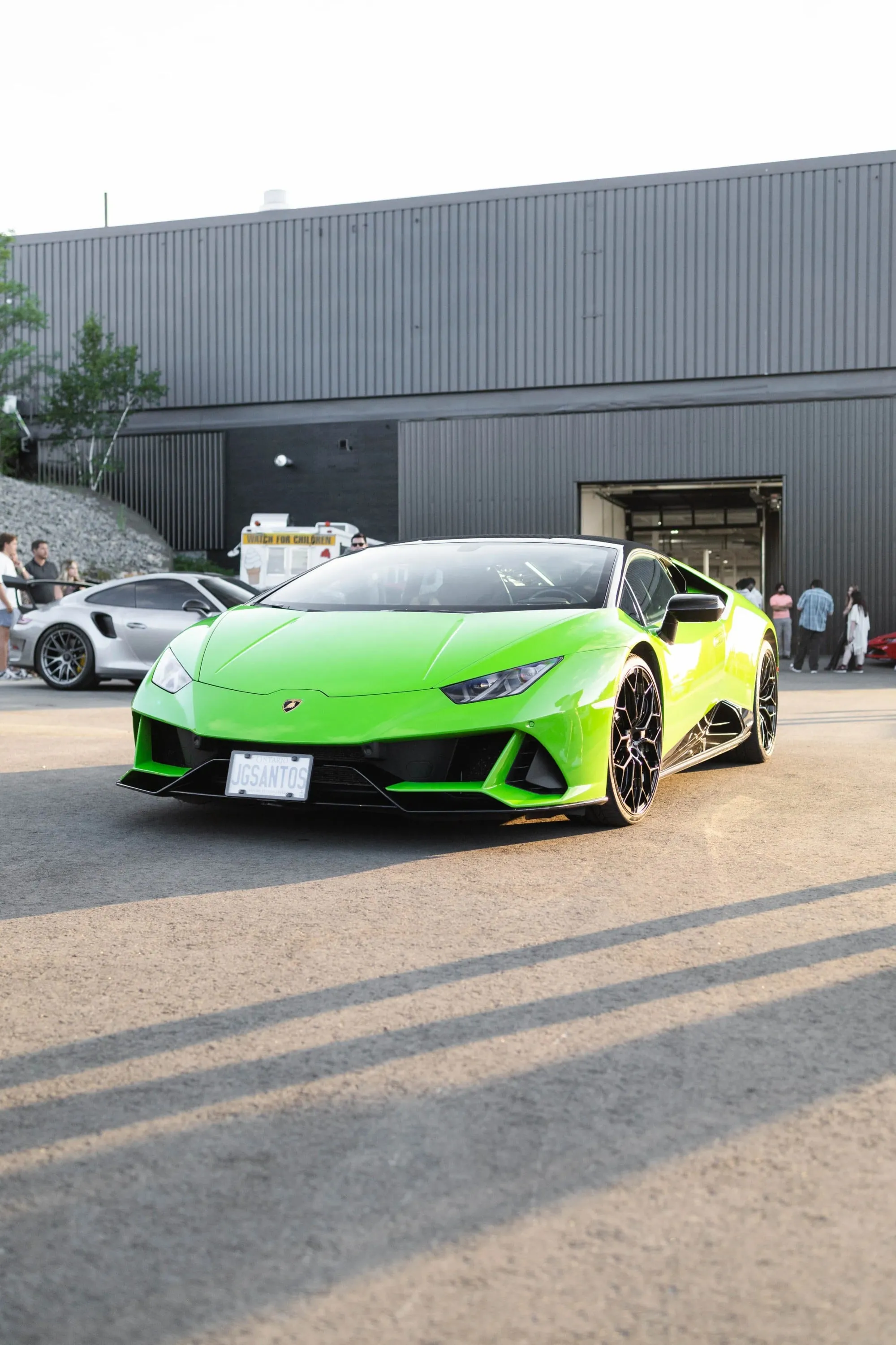 A white sports car parked in a parking lot
