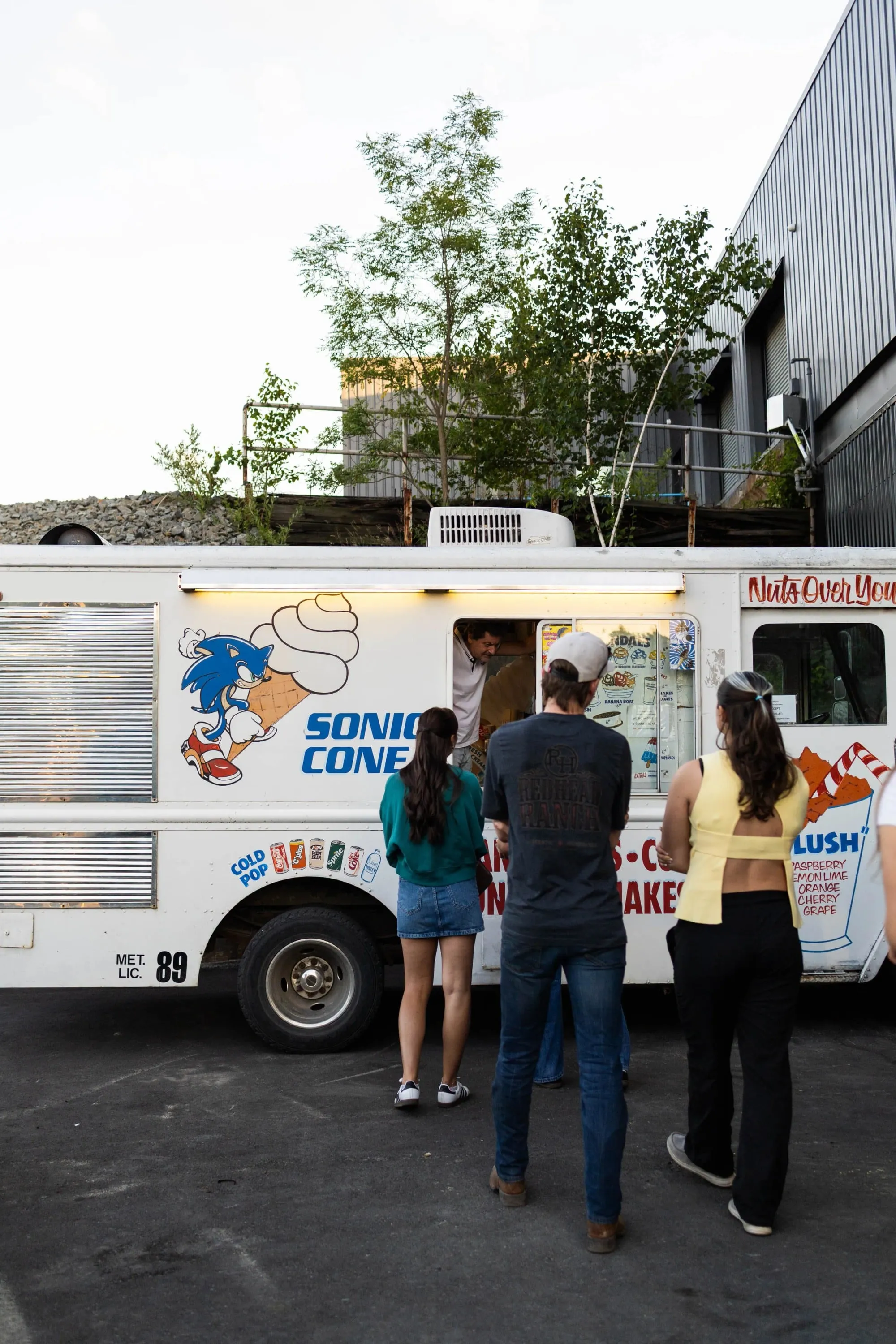A green sports car parked in front of a building