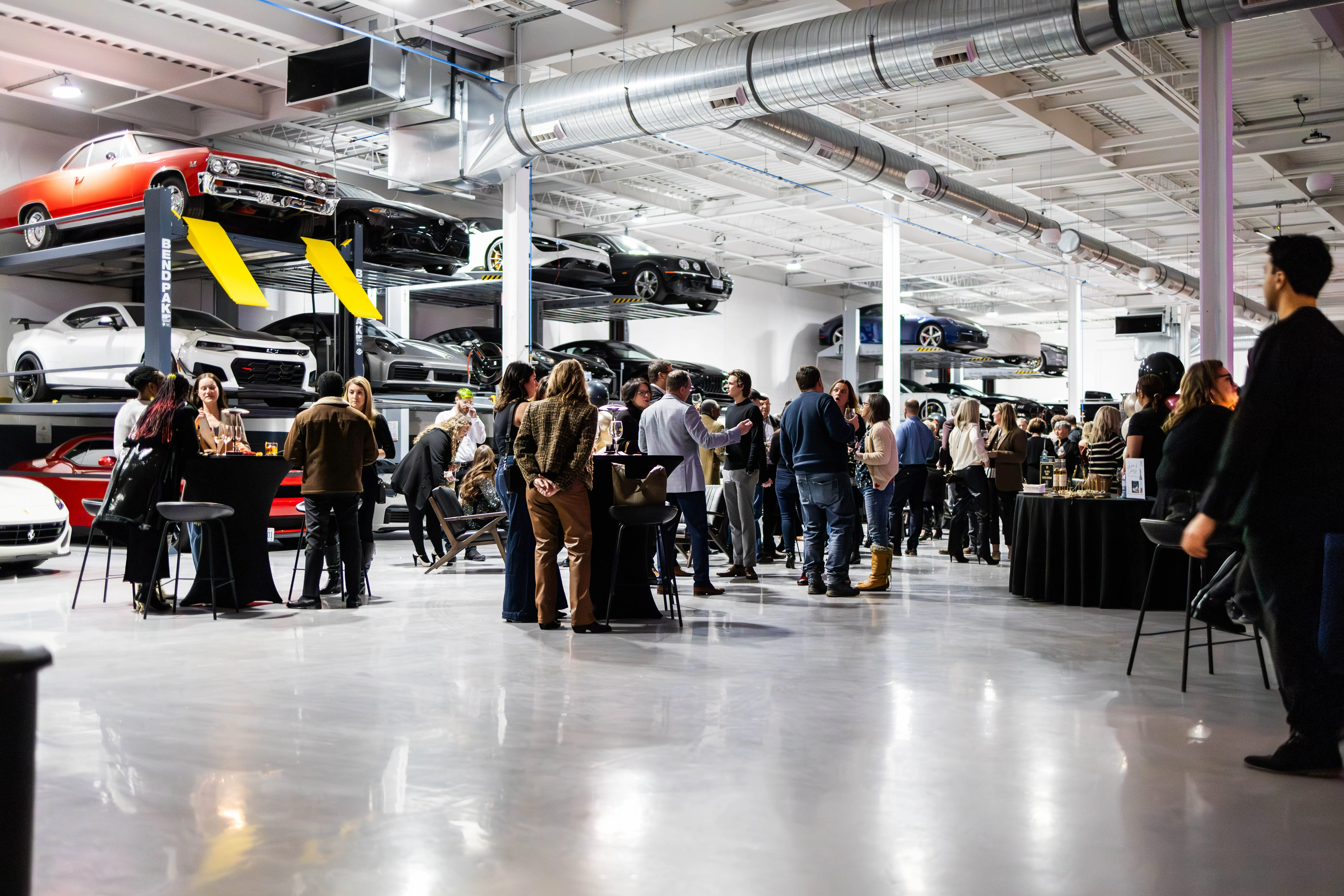 A close-up of a pool table with people chatting in the background around a bar