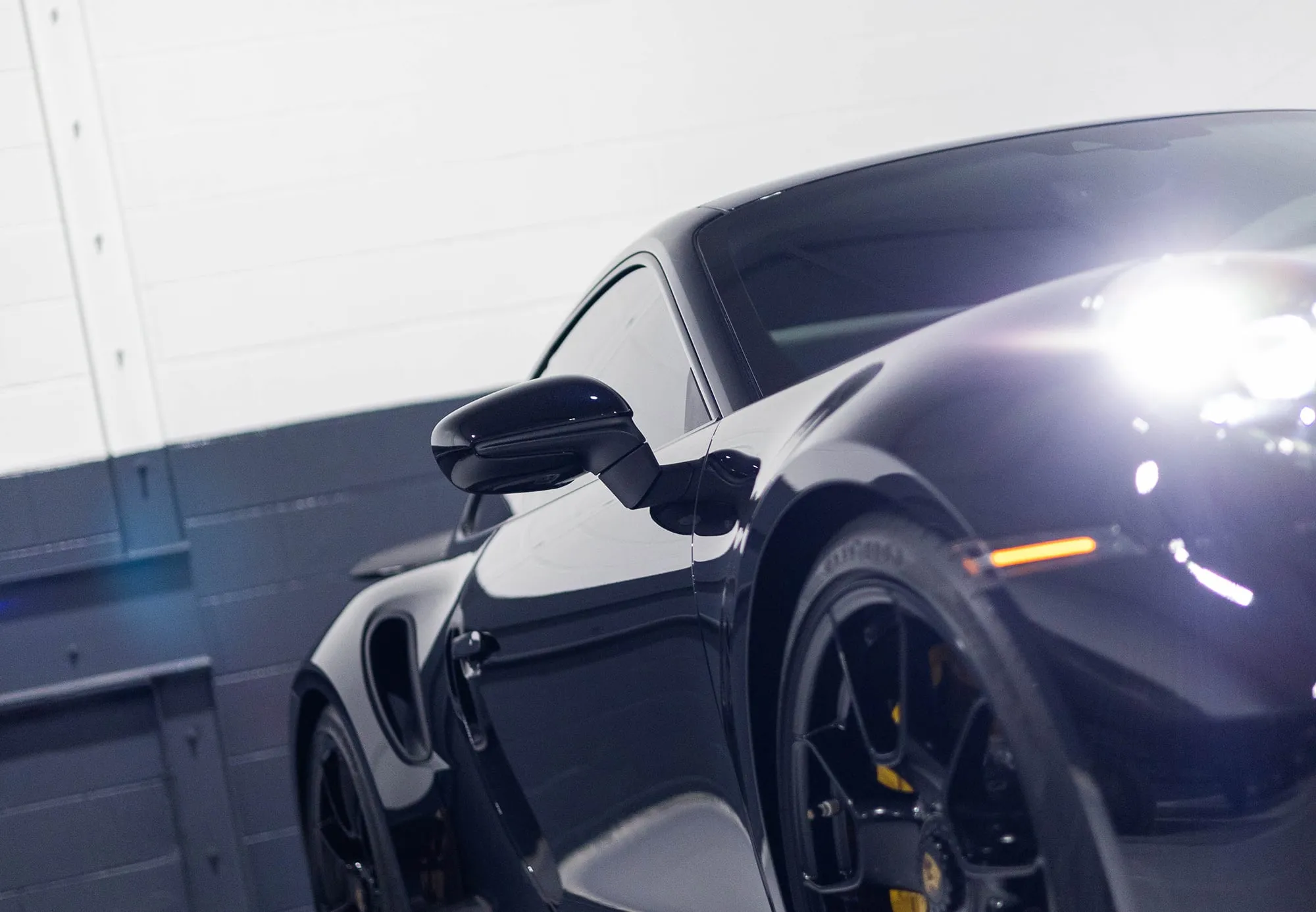 A black sports car parked in a garage