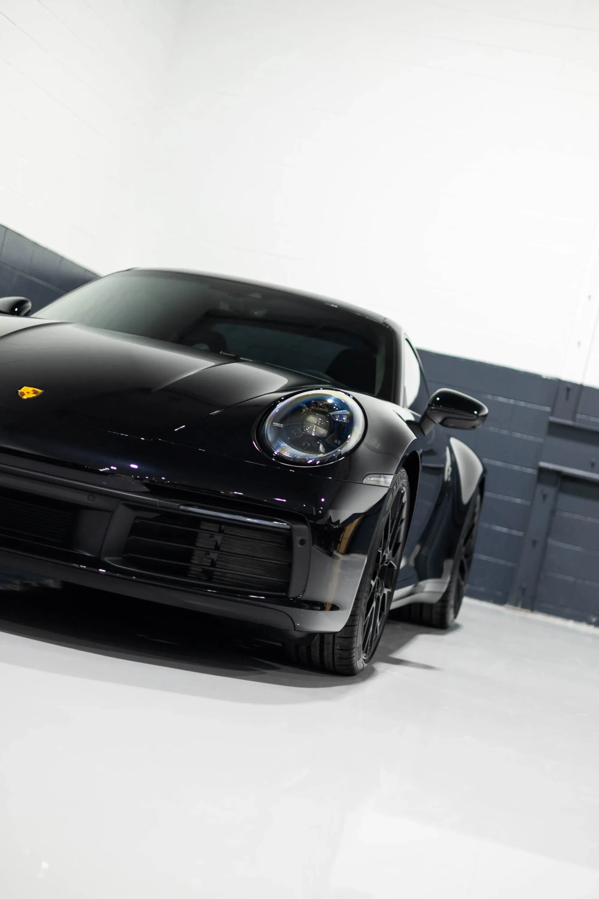 A black sports car parked in a garage