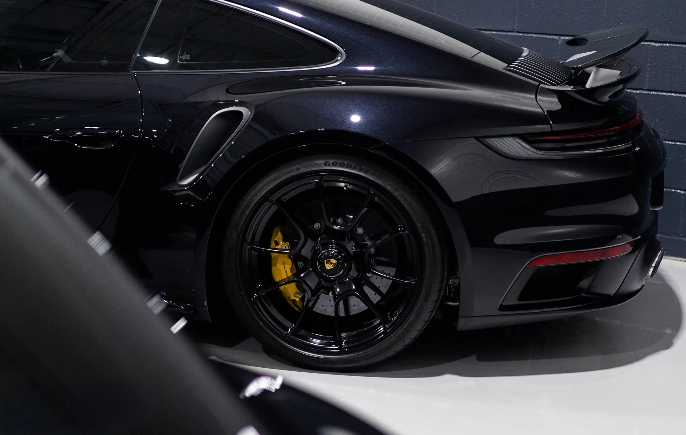 A black sports car parked in a garage